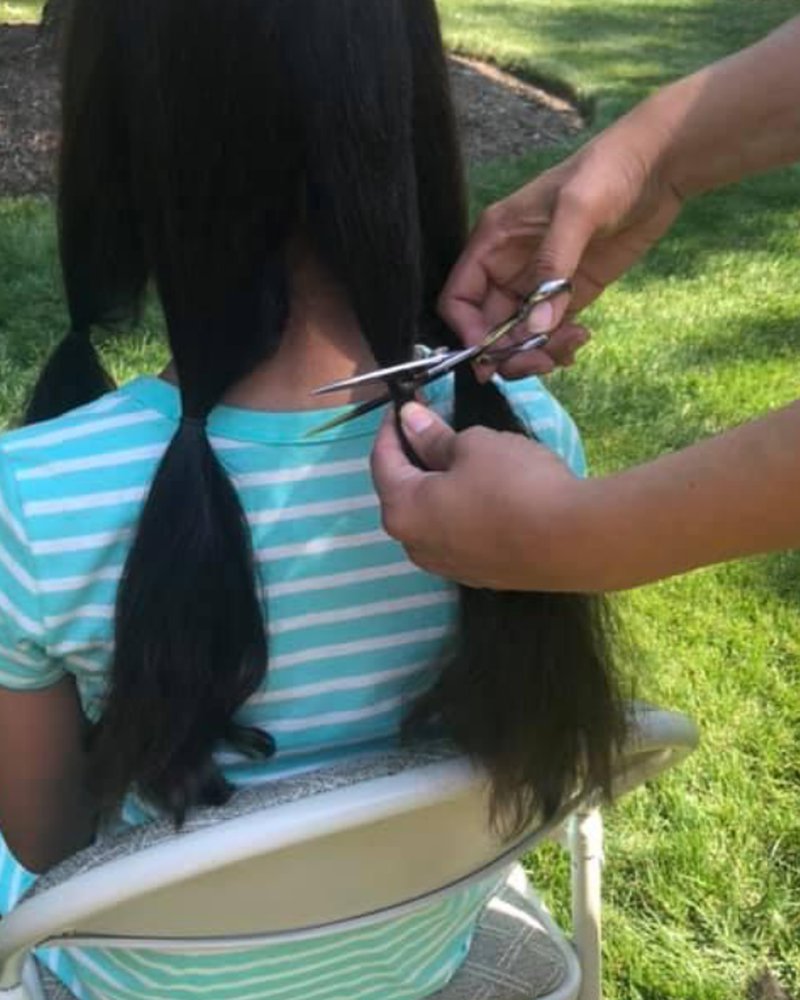 Ava's long hair being cut for donation in 2020
